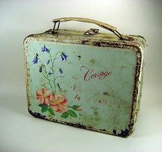 an old suitcase with flowers painted on the side and writing'courage'in red