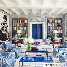 a living room filled with blue and white furniture