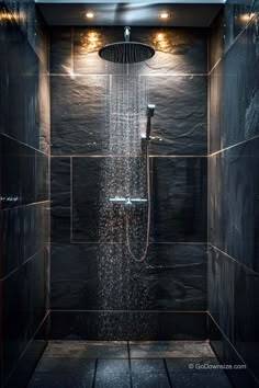 a shower head with rain coming out of it in a tiled wall and floor area