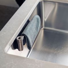 a stainless steel sink with a towel holder