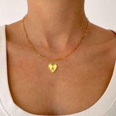 Personalize your wardrobe with the YourLetter Heart Necklace. This stylish piece of jewelry features an elegant gold-colored heart design, and allows you to choose the letter of your choice, making it a unique and thoughtful gift. Express yourself and stay stylish with this personalized necklace. Trendy Gold Charm Necklaces For Valentine's Day, Trendy Heart Charm Necklace As A Gift, Trendy Heart Necklace With Heart Charm As Gift, Trendy Heart Necklace With Heart Charm For Gifting, Trendy Gold Initial Necklace For Personalized Gift, Trendy Gold Name Necklace For Personalized Gift, Gold Heart Pendant Necklace Trendy, Trendy Gold Heart Pendant Necklace, Trendy Gold Heart Necklace For Everyday