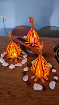 three paper lamps sitting on top of a wooden table