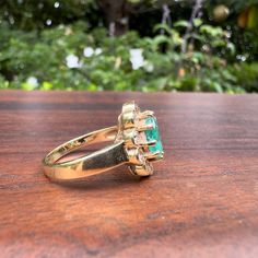 1970s to 1980s-era. Oval 2-carat natural emerald. 14k gold. 10 natural brilliant-cut diamonds, .30 carats total. Diamonds VS-SI quality. Hallmarked on inside of shank. Emerald features "jardin" effects - unique patterns in the stone which increase its value. Size 7.75 4.8 grams. Vintage Emerald Ring With Vvs Clarity, Vintage Oval Emerald Ring Vvs Clarity, Vintage Oval Emerald Ring With Vvs Clarity, Diamond Cluster Ring, Diamond Cluster, Natural Emerald, 2 Carat, Cluster Ring, Brilliant Cut Diamond