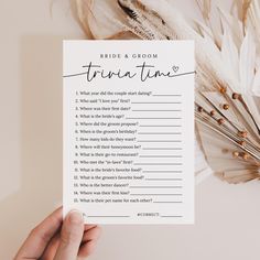 a person holding up a white card with the words bride and groom written on it