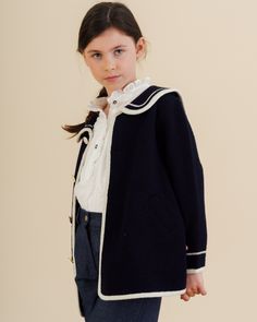 Introducing the Diana Blouse in Off White Plumetis, a timelessly elegant piece perfect for welcoming the season with sophistication. Crafted from delicate cotton for unbeatable comfort, this long-sleeved blouse features a frilled collar and placket, frilled shoulders and delicate mother-of-pearl buttons for a luxurious finish. The Diana Blouse is the perfect addition to your little girl's wardrobe, instantly elevating her look with chic, understated appeal. This blouse combines classic style wit Frilled Collar, Baby Boy Shirts, Girls Special Occasion Dresses, Sailor Style, Navy Coat, Sailor Fashion, Hand Smock, Sailor Collar, Christening Gowns