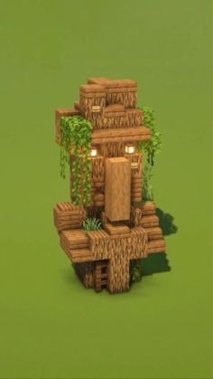 a small wooden structure with plants growing out of it's sides on a green surface