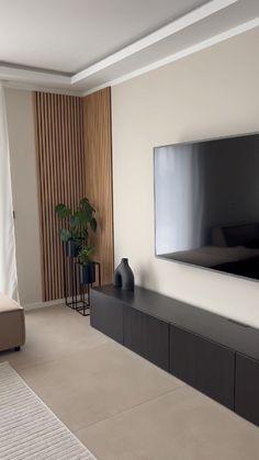 a flat screen tv mounted on the wall in a living room