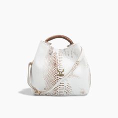 Step into sophistication with our White Leather Handbag featuring a unique round handle, a perfect accessory for those who appreciate elegance with a modern twist. This handbag is meticulously crafted from embossed genuine leather, offering a luxurious texture and feel. The pristine white color, paired with gold metallic details, creates a stunning contrast that enhances any outfit, making it a versatile addition to your wardrobe. Designed with both style and functionality in mind, the handbag f Elegant Handheld Bucket Bag For On-the-go, Luxury Bucket Bag With Top Carry Handle, Elegant Satchel Bucket Bag For On-the-go, Luxury Handheld Hobo Bag With Top Carry Handle, Luxury White Bucket Bag With Top Handle, Luxury White Bucket Bag With Top Carry Handle, Formal Handheld Hobo Bag With Detachable Strap, Luxury Handheld Bucket Bag With Removable Pouch, Elegant Tote Bucket Bag With Removable Pouch