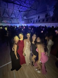 group of women in evening gowns posing for the camera