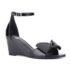 Textured bow details add a feminine twist to the shelby sandal, featuring a wedge heel. With a polished buckle closure on the ankle strap, it pairs perfectly with a sleek sheath dress. Closure Type: BuckleShoe Heel Height: 3 InchesUpper/Outer Base Material: 100% LeatherShoe Lining Material: LeatherSole Material Content: 100% RubberToe Type: Open Toe, Pointed ToeShoe Strap Type: Ankle StrapHeel Style: Wedge HeelCountry of Origin: Imported Elegant Wedge Sandals With Buckle Closure And Round Toe, Summer Patent Leather Heels With Bow, Summer Bow Heels In Patent Leather, Elegant Ankle Strap Wedge Sandals With Buckle Closure, Elegant Wedge Sandals With Buckle Closure For Spring, Elegant Spring Wedge Sandals With Buckle Closure, Spring Patent Leather Wedge Sandals, Spring Formal Wedge Sandals With Buckle Closure, Formal Spring Wedge Sandals With Buckle Closure