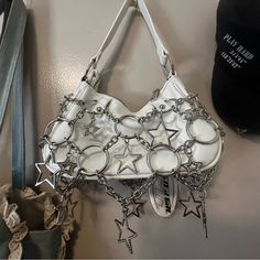 Add A Touch Of Sparkle To Your Ensemble With This Poster Girl Purse, Accented With Star Chains Front And Back. Perfect For The Star Girl Aesthetic! Condition: Brand New #Postergirl #Whitepurse #Purse #Stargirl Silver Handheld Bag With Chain Strap, Silver Chain Shoulder Bag, Silver Shoulder Bag With Chain For Fashion, White Poster Girl Dress, Silver Bling Handheld Bag, Women Poster, Girls Purse, Star Chain, White Purses