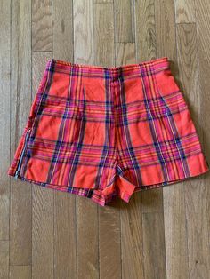 27" waist//Vintage 90s does 60s High Waist Plaid Shorts  Orange plaid shorts with zipper detail along the side of legs. Zipper up back.  Waist 27" Hips 38" Rise 13" Inseam 2" Length 13" Preppy twee professional retro Retro Fitted Short Bottoms, Retro High-waist Bottoms With Built-in Shorts, Retro High Waist Bottoms With Built-in Shorts, Retro Fitted Shorts, Retro Fitted Shorts With Short Leg, Vintage Fitted Shorts With Short Inseam, Fitted High Waist Vintage Shorts, Vintage Fitted High Waist Shorts, Vintage Fitted Shorts