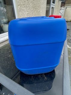 a blue plastic container sitting on top of a car