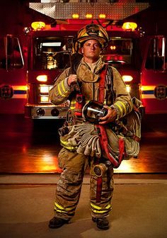 a firefighter standing in front of a fire truck