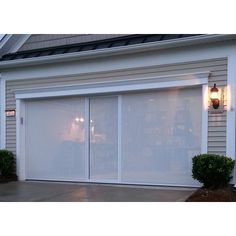 a white garage door with two lights on it