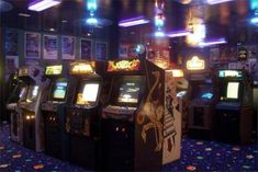 an image of a video game room with arcade machines on the floor and lights in the ceiling