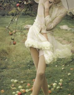 a woman in a white dress holding an umbrella