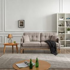 a living room with a couch, coffee table and bookshelf