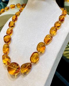 Natural Citrine fine Quality fancy Tumble Shape Necklace with 23 pieces high-End quality Gems by GemShopOnline. These rich color beauty gemstone is hand cut in different sizes & carefully lined up. They are cut in smooth fancy tumble  shape. A special cut that makes these amazing quality gemstones unique. The large necklace is almost eye clean (hardly it will show minor inclusions in some pieces) and is beautifully crystal like clear. It is string with lobster clip & ready to wear.  For safety! Luxury Amber Necklace With Gemstone Beads, Luxury Unique Citrine Necklaces, Luxury Faceted Citrine Necklaces, Luxury Amber Gemstone Necklace, Luxury Multi-stone Orange Jewelry, Elegant Luxury Amber Crystal Necklaces, Amber Gemstone, Artisan Bracelets, Large Necklace