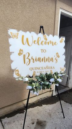 a welcome sign with flowers on it sitting in front of a door that says, welcome to bramna's quinceneara