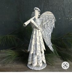 an angel made out of old book pages