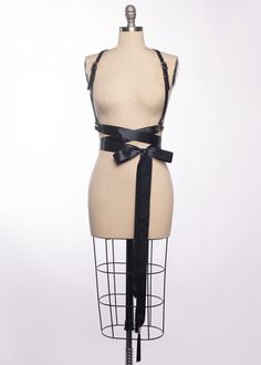 High quality, durable-yet-delicate bespoke harness made in leather or vegan leather. Embellished with tassels. Luxurious wide satin ribbons wrap around the waist and tie into a bow. Choose from gold or silver toned nickel plated steel hardware. Shown in black leather/gold ribbon/gold hardware and black leather/black ribbon/silver hardware. Custom sizing available. All pieces are MADE TO ORDER, standard sizes XS-4XL. If your measurements fall outside these standards or you are unsure of what size Adjustable Belt Harness For Party, Adjustable Strap Harness For Party, Adjustable Straps Harness For Party, Fitted Strapped Harness For Party, Adjustable Strapped Harness For Party, Adjustable Strapped Party Harness, Adjustable Party Harness, Fitted Black Leather Harness, Elegant Fitted Black Harness