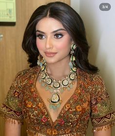 a woman wearing an elaborate necklace and earrings