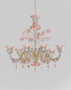 a chandelier with pink and gold flowers on it