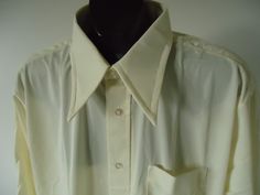 "vintage men's 70s BIG collar shirt    button front, big 4\" collar,  chest pocket, shirt tail hem    LABEL -     K-mart   knit dress shirt      QUINELLA KNIT   65%  acetate  / 35% nylon    light buttery beige           condition -  NOS,  NEW-OLD-STOCK,  excellent     SIZE XL  - 17  chest (side - side ) 26 inch across back shoulders 20 inch sleeve length  34  (24 inch from shoulder) length (back neck to hem) 33  inch" 1970s Collared Shirt, Large Collar Shirt, 70s Collared Shirt, Retro Collared Formal Shirt, Retro Formal Shirt With Spread Collar, Vintage Collared Formal Shirt, Vintage Formal Collared Shirt, Vintage Fitted Business Shirt, Vintage Cream Collared Shirt