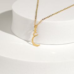 This stunning necklace features a beautifully crafted pendant with a personalized Arabic letter. The elegant design of the letter captures its unique and intricate beauty, making it a focal point of sophistication and charm. The pendant hangs from a delicate chain, perfect for adding a touch of elegance to any outfit. Ideal for everyday wear or special occasions, this necklace makes a meaningful and stylish statement. It also serves as a thoughtful and personalized gift for loved ones, celebrati Crescent-shaped Jewelry Gift, Moon Charm Pendant Necklace For Wedding, Elegant Moon Charm Necklace For Wedding, Symbolic Gold Initial Pendant Jewelry, Elegant Initials Charm Necklace, Elegant Gold Initials Necklace, Elegant Crescent Necklace For Wedding, Elegant Crescent Wedding Necklace, Elegant Gold Initial Pendant Name Necklace