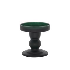 a green cup sitting on top of a black stand