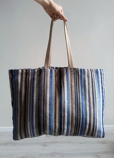 Meet Martinz Studio's versatile Big Beach Bag – the ultimate blend of style and function for any adventure! With durable leather straps and a spacious design, it's perfect for beach days, shopping trips, travel, gym sessions, or casual strolls. A convenient pocket secures your valuables, while the roomy interior holds all your essentials with ease. Made from stunning striped blue and beige textured fabric, this boho tote adds a touch of elegance to your everyday style. Its unique fabric pattern and exceptional craftsmanship make it a true head-turner wherever you go. Everyday Striped Bags With Leather Handles, Striped Tote Beach Bag For Everyday, Everyday Striped Tote Beach Bag, Brown Travel Bag With Striped Lining, Travel Beach Bag With Striped Lining, Large Bags With Braided Handles For Daily Use, Large Shoulder Bag With Braided Handles For Travel, Rectangular Beach Bag With Striped Lining For Travel, Striped Tote Beach Bag For Shopping