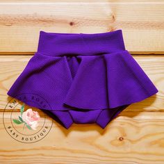 Adorable handmade purple bummie skirt for baby girls. Hair bow comes on a nylon headband. Baby skirts run true to size.  Please order the size that your child is currently wearing. Newborn - 5-8lbs 0-3 months - up to 9lbs 3-6 months - up to 12.5lbs 6-9 months - up to 16.5lbs 9-12 months - up to 20.5lbs 12-18 months - up to 24.5lbs 18-24 months - up to 27.5lbs 24 months - up to 30lbs Click to view more items available: www.etsy.com/shop/emmarosebabyboutique *Fabric placement may vary slightly fro Cute Tiered Skirt Shorts With Ruffles, Stretch Purple Skort With Built-in Shorts, Purple Stretch Skort With Built-in Shorts, Cute Ruffled Skort For Party, Cute Party Skort With Ruffles, Fitted Purple Skort With Built-in Shorts, Fitted Purple Bottoms With Elastic Waistband, Cute Fitted Short Skort, Cute Fitted Party Bottoms