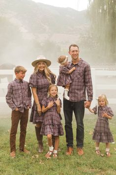 a family poses for a photo in the fog