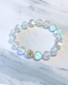 These exceptionally beautiful bracelets are made with aura quartz beads that reflect the light with a rainbow of colors. The CZ rhinestone accent is of excellent quality.  Sz: 7.5 Girly Bracelets, Beautiful Bracelets, Moonstone Bracelet, Quartz Beads, Glass Bracelet, Diy Crafts Jewelry, Cute Bracelets, Quartz Bracelet, Aura Quartz