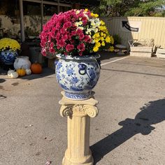 a blue and white vase with flowers in it