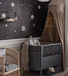 a baby's room with stars on the wall and a crib in the corner