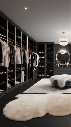 a walk - in closet with black walls and white fur rugs on the floor