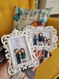 two frames with family pictures on them sitting in front of a yellow chair and pillow