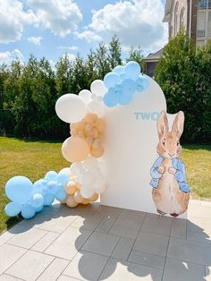 a balloon arch with an image of peter rabbit on it