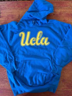 Vintage UCLA Bruins Hoodie Sweatshirt  Size XL Extra Large See pics for measurements  Quality Reverse Weave Material  80/20 Cotton Poly  Quality Brand  Fine condition Quick shipping.  We ship same or next day with USPS MAIL  We are a small family business and we appreciate your purchase, Godspeed ! Collegiate Hooded Tops For Sports Season, Fan Gear Hooded Top With Letter Print, Collegiate Hooded Top For Sports Events, Fan Gear Hoodie, Team-colored Hooded Top For Streetwear, Team-colored Cotton Hooded Top, Fan Apparel Sweatshirt With Double-lined Hood, Fan Apparel Hoodie With Double-lined Hood, Collegiate Crew Neck Top With Drawstring Hood