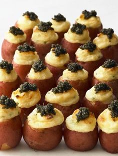 small red potatoes with black cavias on them are arranged in the shape of a pyramid