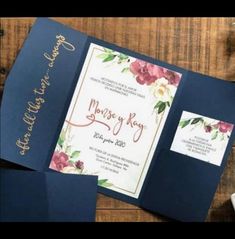 the wedding stationery is laid out on top of each other, including two cards and some coins