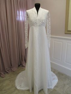 a wedding dress on display in front of a window