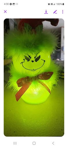 a neon green stuffed animal sitting on top of a table