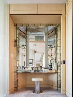 a bathroom with marble counter tops and mirrors