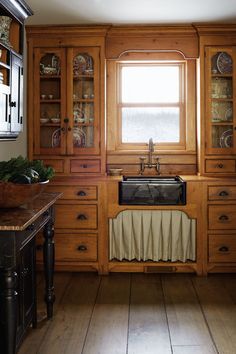 a kitchen with wooden cabinets and a black sink