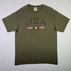 VINTAGE USA Shirt Large Olive Green America Patriotic Crew Neck T-shirt Mens  Excellent Vintage Condition  Size: Large  Color: Olive Green  100% Cotton Machine Washable  See photographs for MEASUREMENTS *To ensure the best fit, please measure the chest and total length of your favorite-fitting shirt and compare measurements to those of this particular item Same Day - Next Business Day Shipping Show off your patriotism with this vintage USA shirt in olive green. Made by Hanes, this shirt features American Retro Short Sleeve Cotton T-shirt, Vintage Crew Neck Shirt With Graphic Print, American Retro Cotton Crew Neck T-shirt, Vintage Crew Neck T-shirt With Letter Print, Vintage Crew Neck Shirt With Letter Print, Vintage Green Short Sleeve T-shirt, Vintage Cotton Shirt With Letter Print, Vintage Cotton Shirt With Crew Neck, Green Vintage Short Sleeve T-shirt