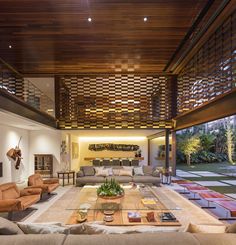 a large living room with couches and tables in front of an open floor plan