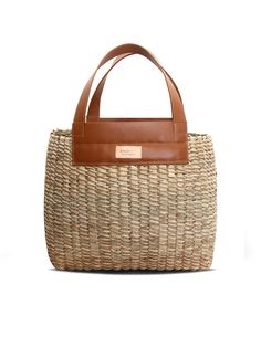 Make even the most relaxed outfits that little bit more chic with this basket bag by Khokho Collection. It’s handwoven by the brand’s all-female team of artisans from locally-sourced natural fibers and finished with tan leather handles and trims. Wear yours with a lightweight linen suit as soon as the weather heats up. - Top handles, open top - Natural fibers, cow leather - Any variations in tone or texture are inherent to the handcrafted nature of each bag - Artisanally crafted by a local femal Eco-friendly Woven Leather Bucket Bag, Chic Jute Straw Bag With Woven Leather, Chic Beach Bag With Top Handle In Natural Fiber, Casual Woven Top Handle Beach Bag, Chic Straw Bag With Woven Leather Details, Chic Handwoven Natural Fiber Bucket Bag, Chic Handwoven Natural Bucket Bag, Woven Bucket Bag With Top Handle In Natural Fiber, Spring Beach Bag In Natural Woven Leather